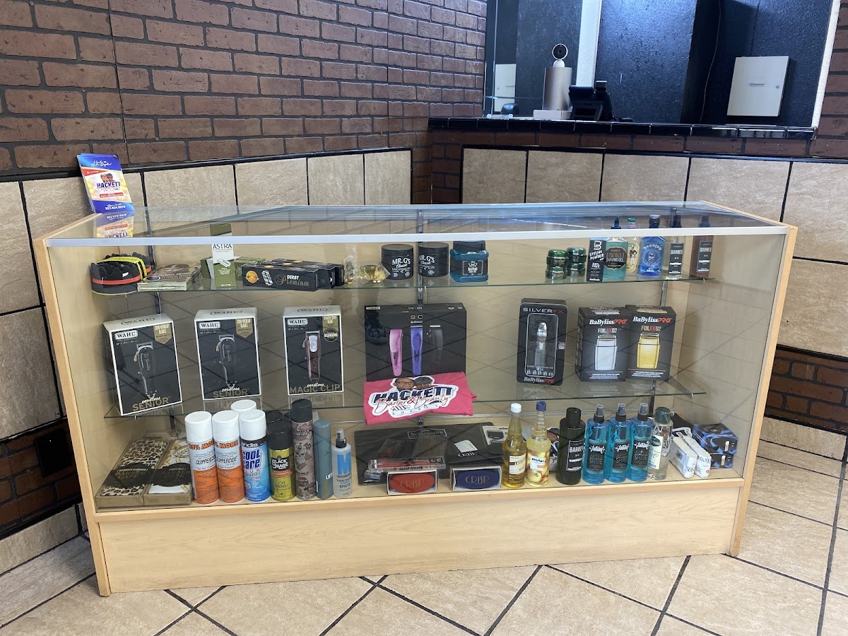 Glass display case stocked with professional barber supplies