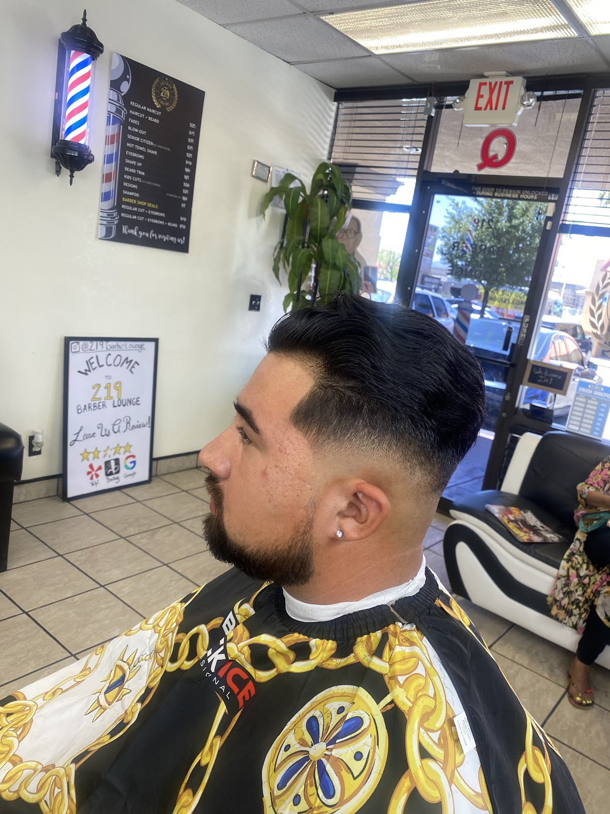 Client showcasing a sharp low fade and styled hair